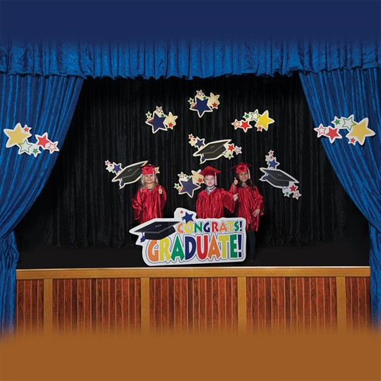 happy preschool graduates on a decorated stage